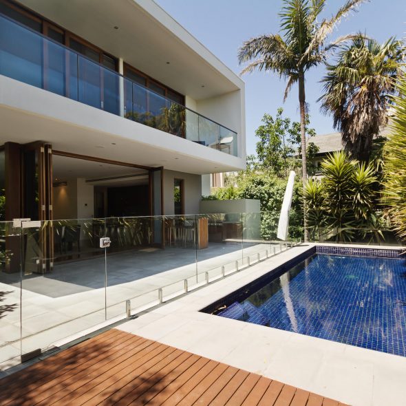 Rear garden of a contemporary Australian home with tiled swimming pool